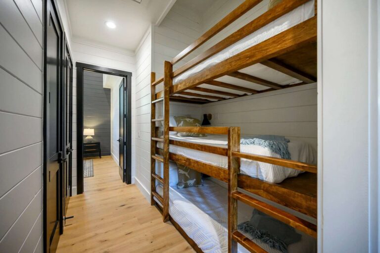 Hallway bunk beds inside Blue Note Broken Bow cabin offering additional sleeping space for large family vacations near river activities.