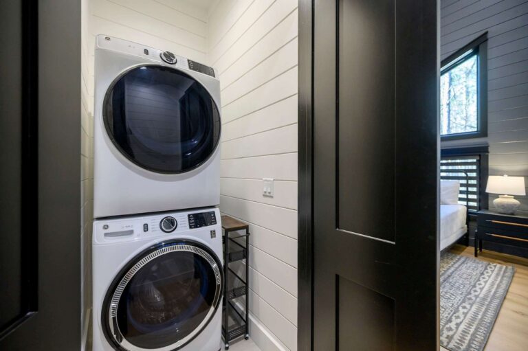 Modern laundry room inside Blue Note Broken Bow cabin with washer and dryer for convenient family cabin stays near river activities.
