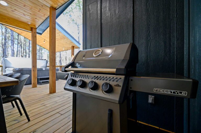 Outdoor grill station on covered patio at Blue Note Broken Bow cabin with luxury cooking and entertainment space.
