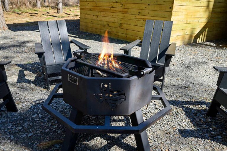 Outdoor fire pit with Adirondack chairs at Blue Note Broken Bow cabin designed for relaxing evenings and family gatherings.