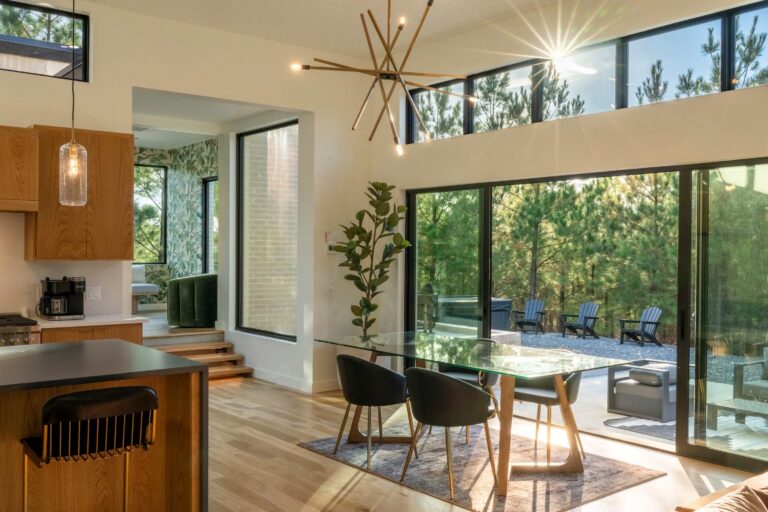 Dining table elegantly set with the open-concept kitchen visible in the background.